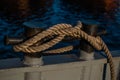 Mooring ropes coiled on ferry deck. Strong braided ropes for anchoring the boat in sunset light. Close up. Blue Royalty Free Stock Photo