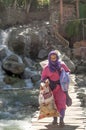 Moorish woman crossing a bridge