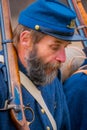 MOORPARK, USA - APRIL, 18, 2018: Portrait of old man wearing uniform and holding a gun in his shoulder, at the Civil War