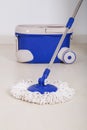 Mop and blue bucket for cleaning floor Royalty Free Stock Photo