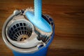 Mop and blue bucket ready for cleaning floor Royalty Free Stock Photo