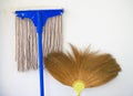 Mop and broom propped against a wall