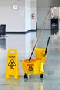 Mop and Bucket with Caution Sign Royalty Free Stock Photo