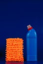 mop cloth and blue bottle with reading agent on blue background Royalty Free Stock Photo