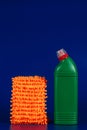 mop cloth and green bottle with reading agent on blue background Royalty Free Stock Photo