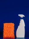 mop cloth and white bottle with reading agent on a blue background Royalty Free Stock Photo