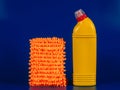 mop cloth and yellow bottle with reading agent on blue background Royalty Free Stock Photo