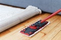 Mop with rag cleaning wooden in room, closeup Royalty Free Stock Photo