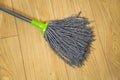 MOP for wet cleaning on the background of brown laminate in the apartment, care household