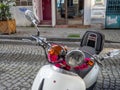 Moped steering wheel decorated with flowers. Aesthetics. Two-wheeled light transport. Bike wheel. White moped Royalty Free Stock Photo