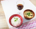 Moqueca of fish and bell peppers, food Brazilian, served with white rice, on a wooden table