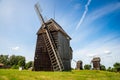 Moraczewo, Poland - August 09, 2021. Wooden windmills in Summer on the green meadow