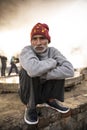 Moradabad, Uttar Pradesh- January 12 2022- Portrait of an old aged man from village sitting on a stone pedestal Royalty Free Stock Photo