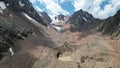 A moraine lake among a glacier covered with rocks