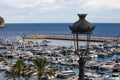 Moraira fishing port with wrought iron public lighting luminaire in the foreground