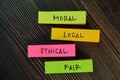 Moral - Legal - Ethical - Fair write on sticky notes isolated on Wooden Table