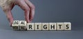 Moral or legal rights symbol. Businessman turns wooden cubes and changes words moral rights to legal rights on a beautiful grey