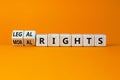Moral or legal rights symbol. Turned wooden cubes and changed words moral rights to legal rights on a beautiful orange background