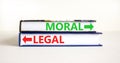 Moral or legal symbol. Concept word Moral or Legal on beautiful books. Beautiful white table white background. Business and moral