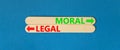 Moral or legal symbol. Concept word Moral or Legal on beautiful wooden stick. Beautiful blue table blue background. Business and