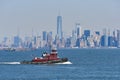 Moran tugboat Kimberly Turecamo, moves across New York Harbor, in front of the Lower Manhattan NYC Skyline Royalty Free Stock Photo