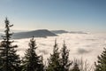 Autumn Moravskoslezske Beskydy mountains scenery from Lysa hora hill in Czech republic with only highest hills above mist