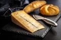 Morbier cheese. Delicious french cheese with mold on black table Royalty Free Stock Photo