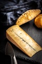 Morbier cheese. Delicious french cheese with mold on black table Royalty Free Stock Photo