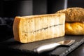 Morbier cheese. Delicious french cheese with mold on black table Royalty Free Stock Photo