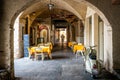 Morcote village scenic view of arched gallery street with pizzeria restaurant entrance and Piaggio scooter in Italian Ticino