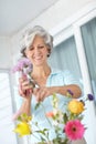 More colors make it merrier. a senior woman enjoying some flower arranging at home.