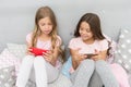 We are more connected than ever. Little children use mobile phone in bed. Mobile communication. Cellular communication