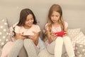 We are more connected than ever. Little children use mobile phone in bed. Mobile communication. Cellular communication