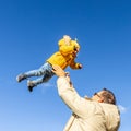 More, more,...dad, that& x27;s fun. Happy young father throws his cute little baby boy up in the air. Father& x27;s Day Royalty Free Stock Photo