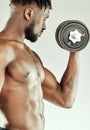 More lifting, more muscle. a muscular young man lifting dumbbells. Royalty Free Stock Photo