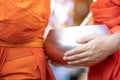 More monks with hand holding give alms bowl which came out of the offerings in the morning at Buddhist temple, Culture Heritage Si