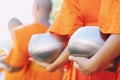 More monks with hand holding give alms bowl which came out of the offerings in the morning at Buddhist temple, Culture Heritage Si