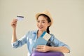 More opportunities! Travel concept. Studio portrait of pretty young woman holding passport and banking card