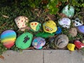 More Painted Rocks Along a Sidewalk