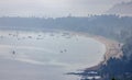 Shallow fishing boats anchor at the beach on thick fog days. Royalty Free Stock Photo