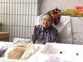 The more than and 90 year old Chinese old lady, sale of goods in the market