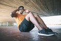 The more you move, the more you get from life. a young man doing sit ups against an urban background. Royalty Free Stock Photo