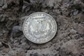 1879 Morgan Silver Dollar On Ground in Dirt Back View