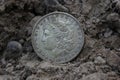 1879 Morgan Silver Dollar On Ground in Dirt Front View