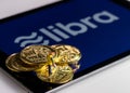 Golden coins on top of tablet computer for Libra cybercurrency Royalty Free Stock Photo