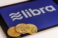 Golden coins on top of tablet computer for Libra cybercurrency Royalty Free Stock Photo