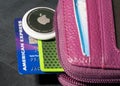 Apple AirTag being inserted in a small credit card wallet