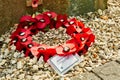 A wreath of artificial red poppies laid by members of the British armed forces at the monument to the bombing of Lake Moehne