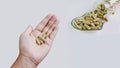 Moringa capsules on hand with group of medicine in heart pattern bowl Royalty Free Stock Photo
