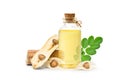 Moringa Oil in glass bottle with dried seeds